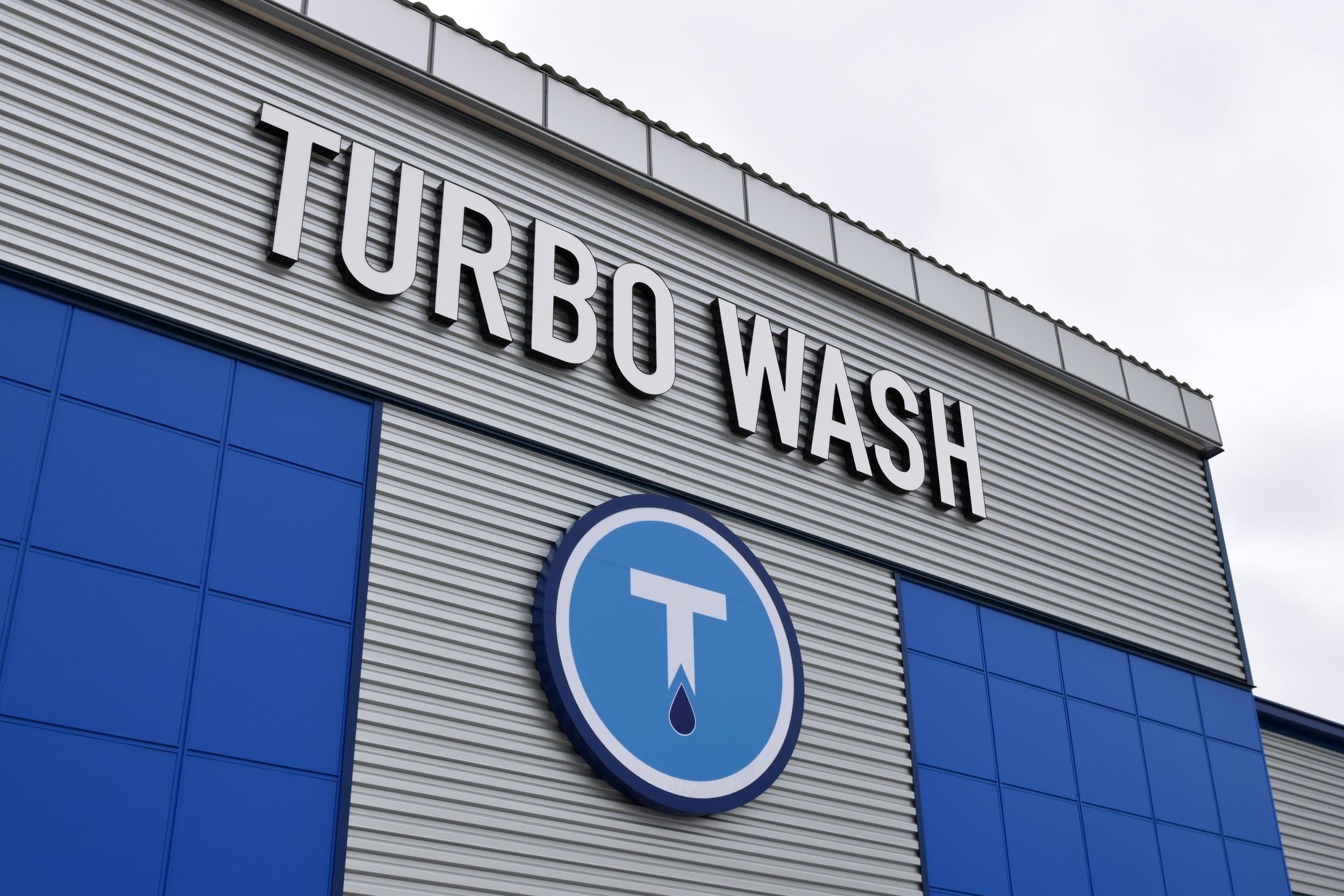 A Turbo Wash team member helping a customer